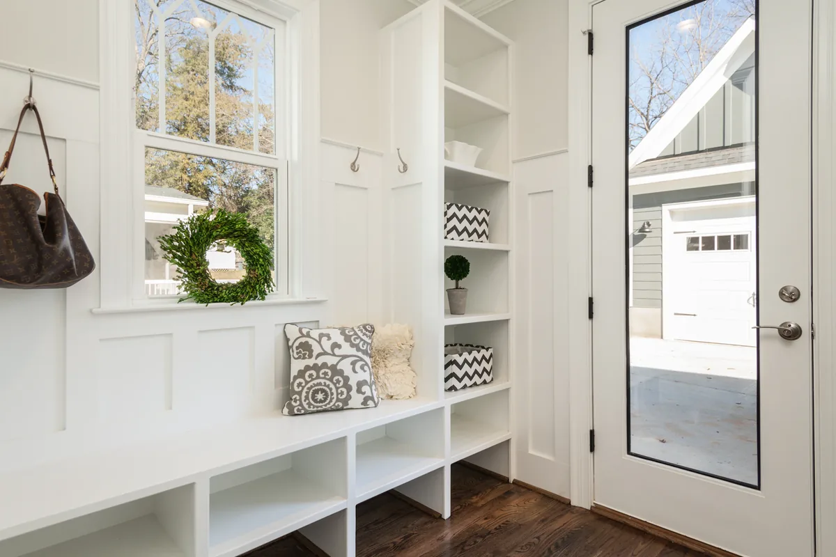 A finished Florida mudroom with sealed waterproof tile flooring, a built-in bench, and moisture-tolerant cabinetry