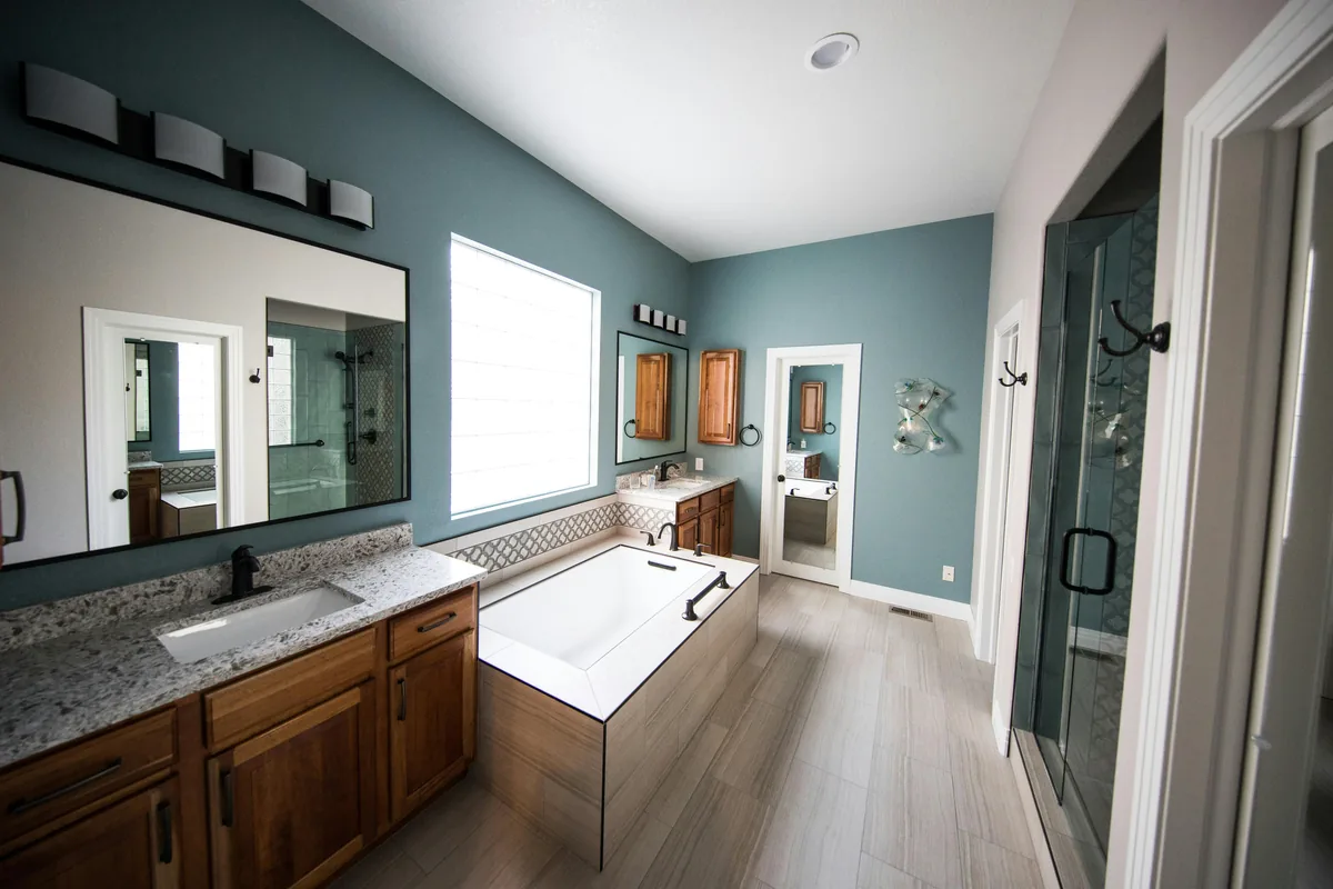 A finished Florida shower remodel with slip-rated tile, a niche, frameless glass, and a humidistat exhaust fan