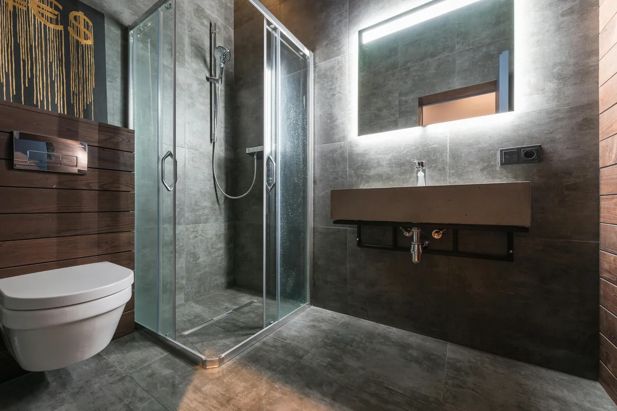 A compact Florida bathroom stripped to the studs with a bonded waterproof membrane on the corner shower walls