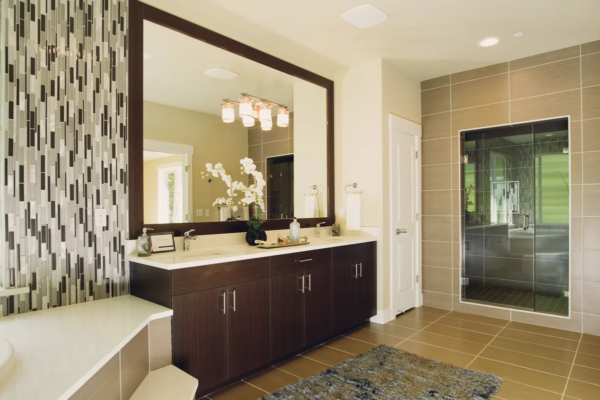 A curbless walk-in shower under construction in Florida showing the recessed slab, sloped pan, and linear drain