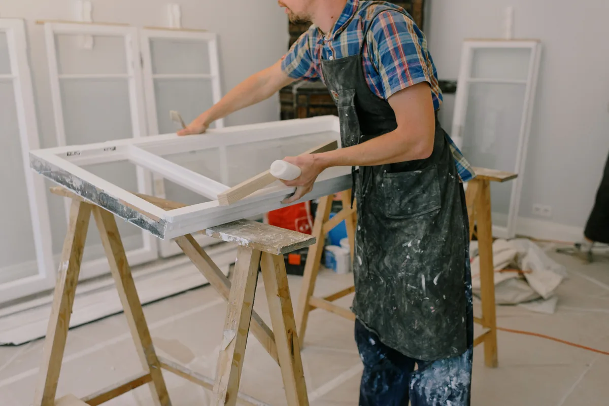 Installer scribing a built-in side panel to follow an uneven Florida block wall