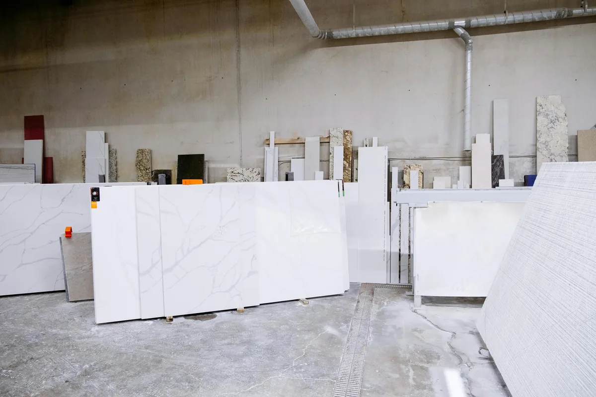 Fabricator taking a digital template of kitchen cabinets before quartz countertop installation in Florida