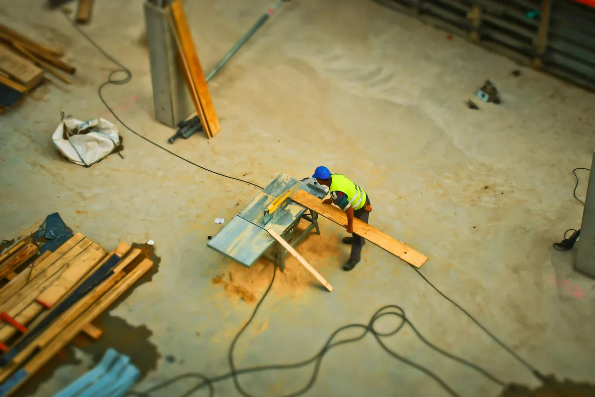 Installer applying a liquid waterproofing membrane over a sloped Florida bathroom substrate before setting tile