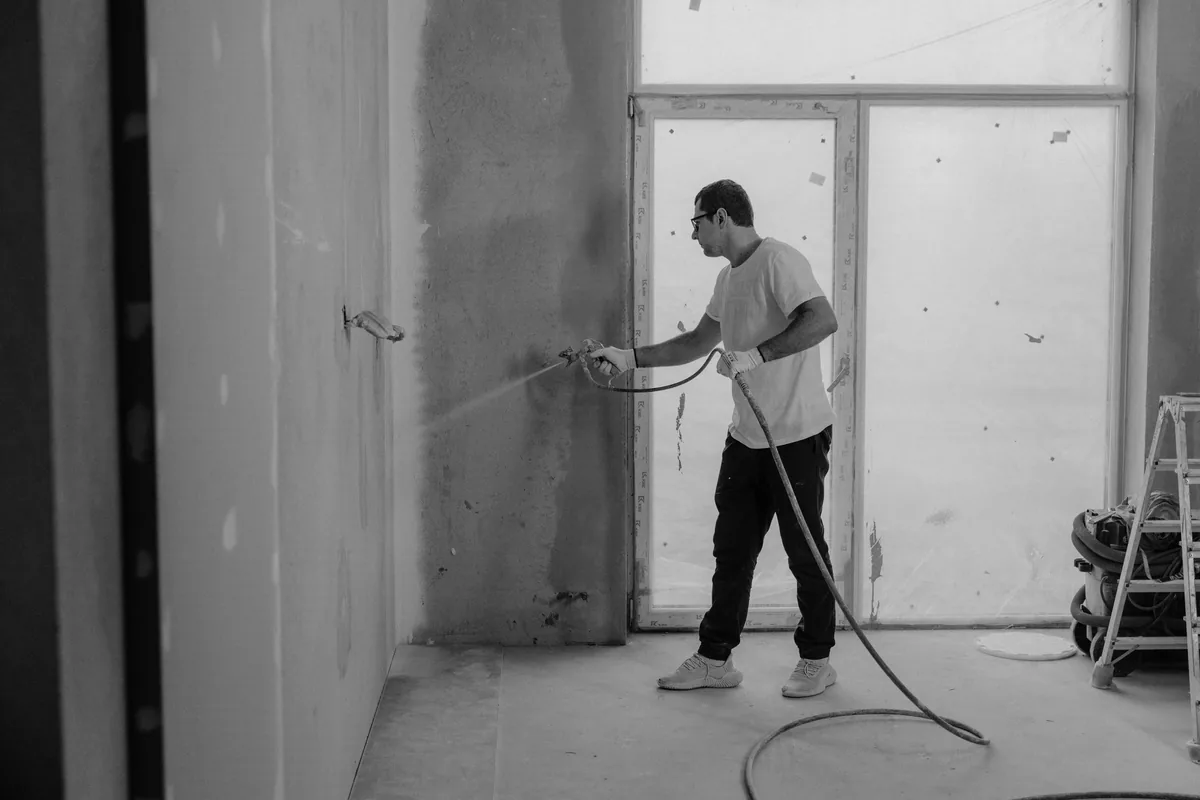 Technician diamond-grinding a Florida garage slab to a concrete surface profile before applying a coating