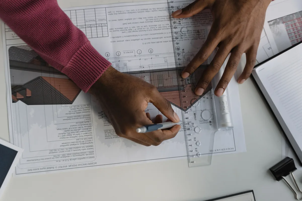 A general contractor reviewing stamped construction drawings on a Florida job site