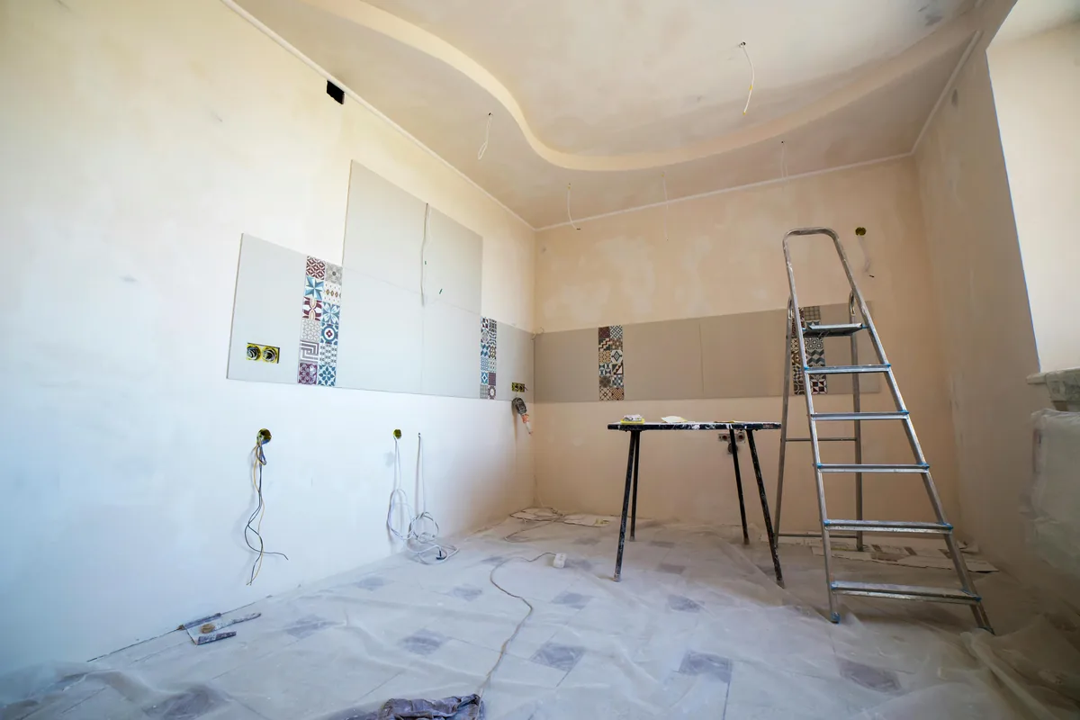 Drywall finisher taping and coating joints to a smooth Level 4 finish in a Florida room