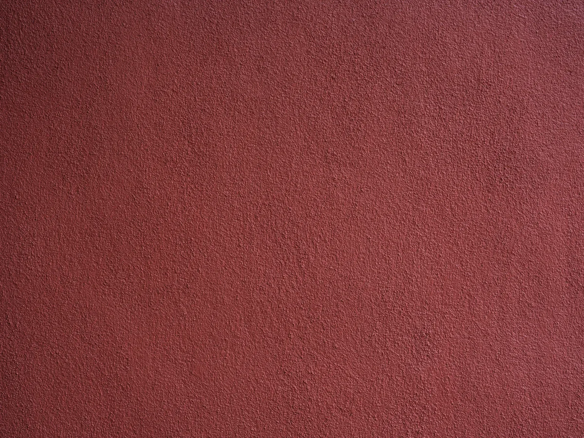 Close-up of knockdown wall texture next to a finer orange-peel sample on a Florida wall